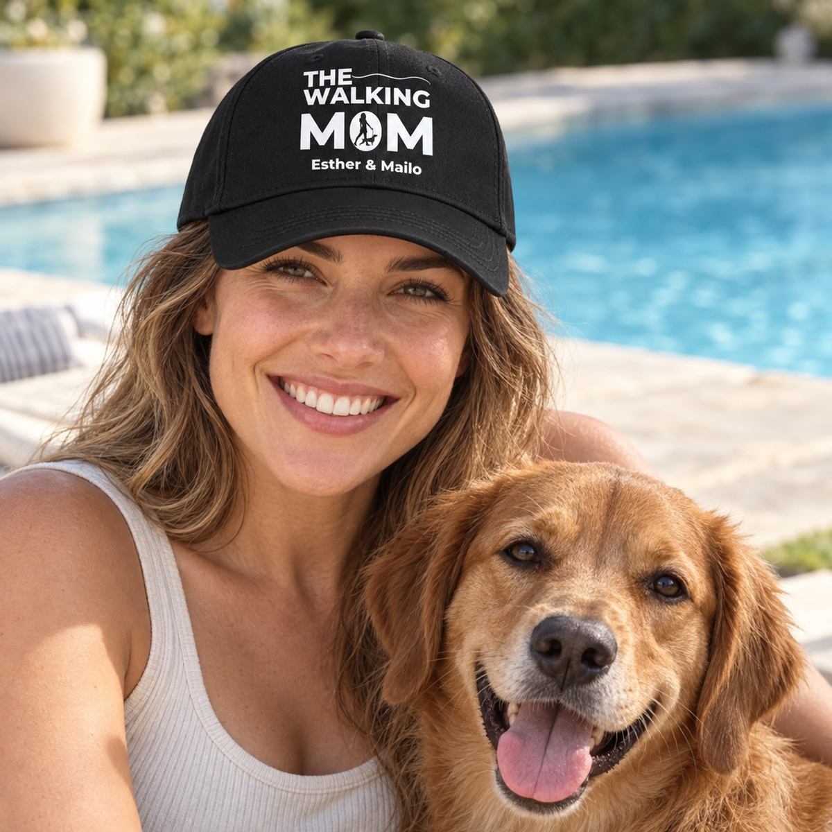 Black cap with “THE WALKING MOM” print and personalized names, worn by a woman with a dog.
