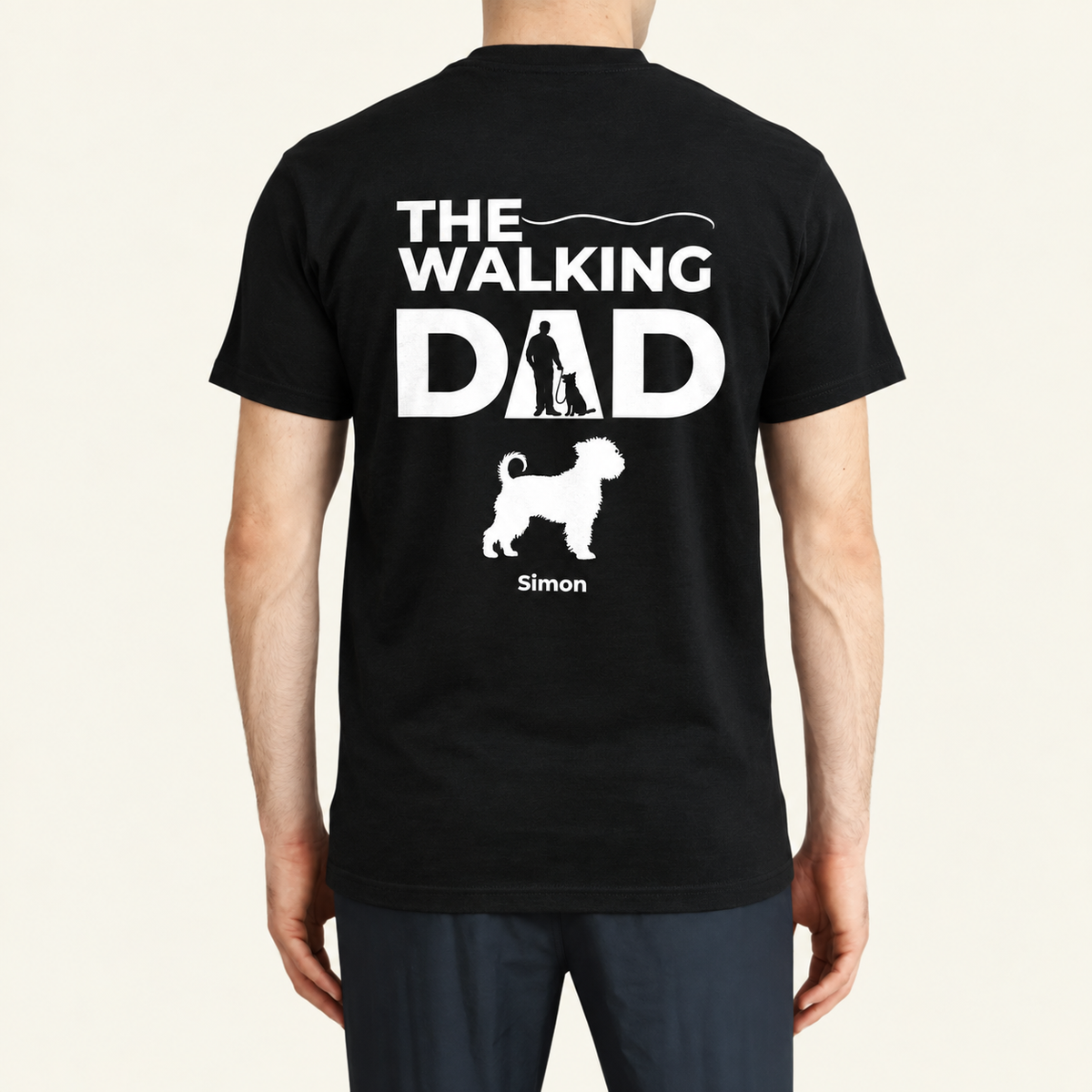 Black T-shirt printed with "THE WALKING DAD" and a dog-walking silhouette. Personalized with the name Simon.