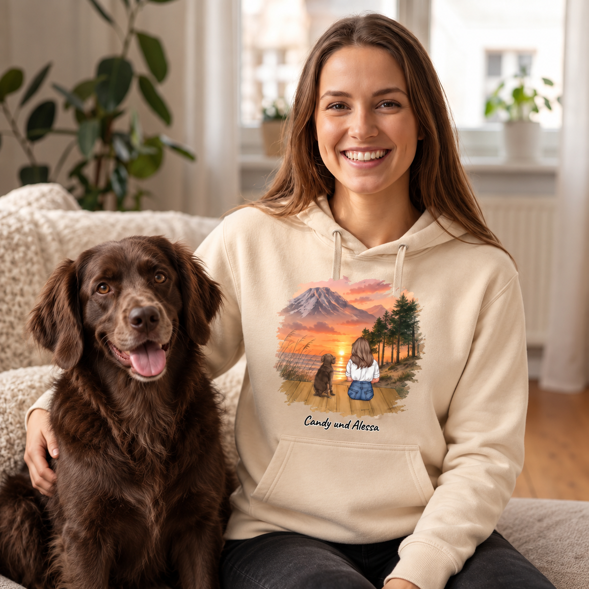 Beige hoodie with personalized motif of a woman and her dog in front of a mountain landscape.