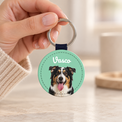 Personalized faux leather keychain with dog portrait and blue strap.