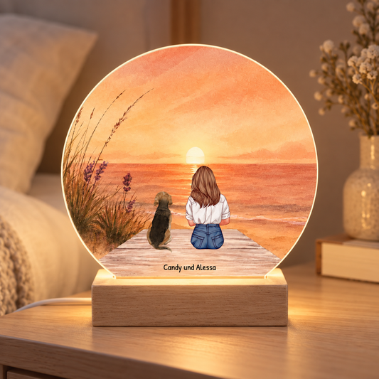 Personalized LED night light with an illustration of a woman and her dog on the beach at sunset. Wooden base.