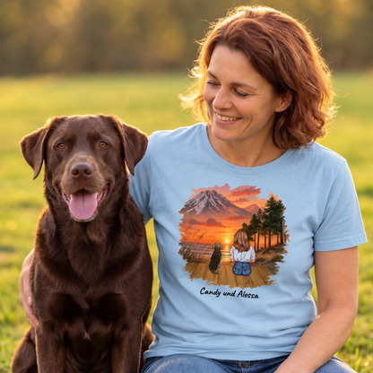 Blue T-shirt with graphic print of a woman and her dog in front of a mountain landscape.