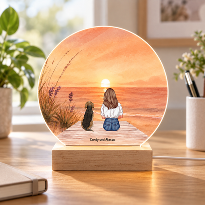 Personalizable LED night light with illustration of a girl and a dog at sunset. Wooden base.