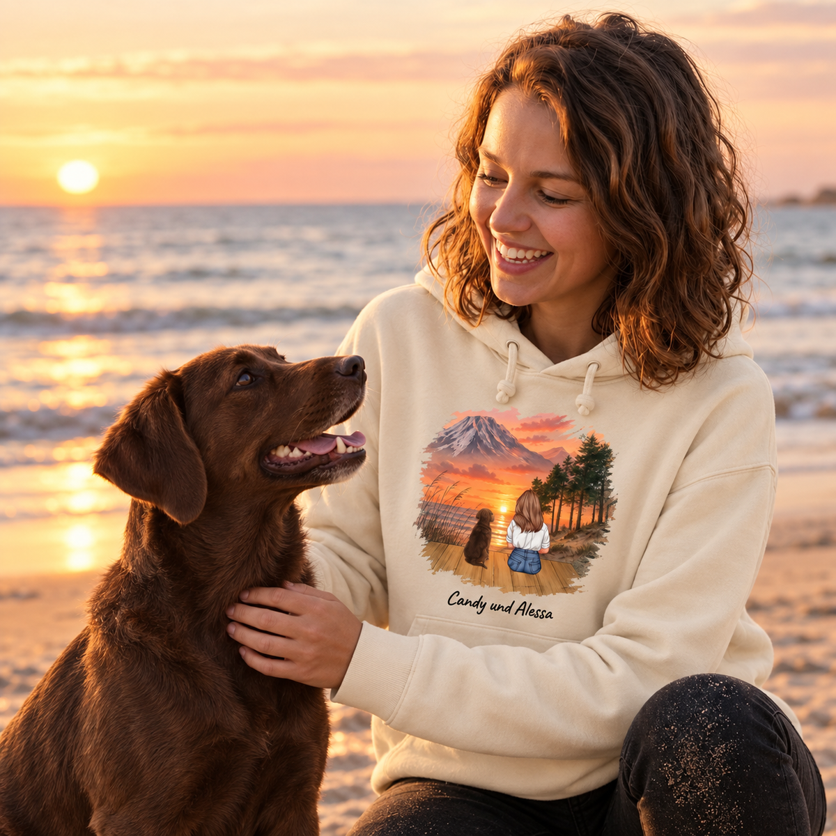Beige hoodie with animal motif, wearer with dog on the beach at sunset.