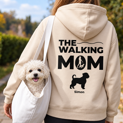 Beige hoodie printed with "THE WALKING MOM" and dog motif, worn by a person with a dog.