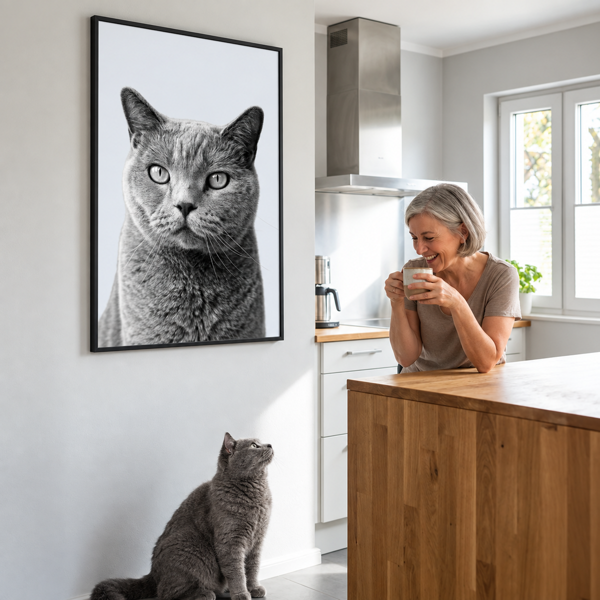 Smiling person showing a personalized pet portrait of a grey cat on the wall.