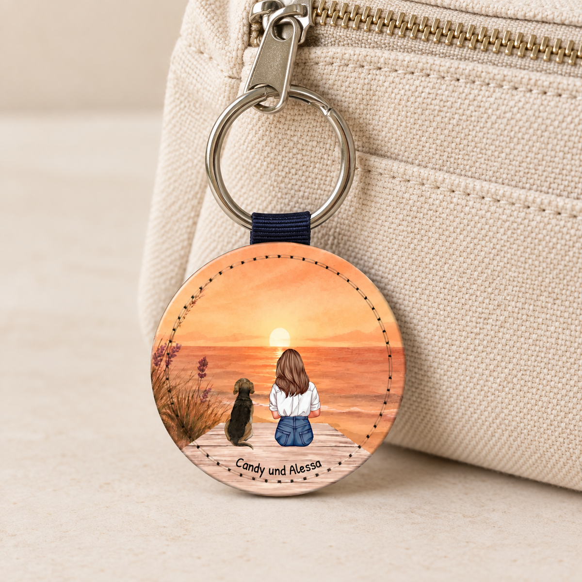 Personalized keychain with illustration of a woman and a dog against a sunset.
