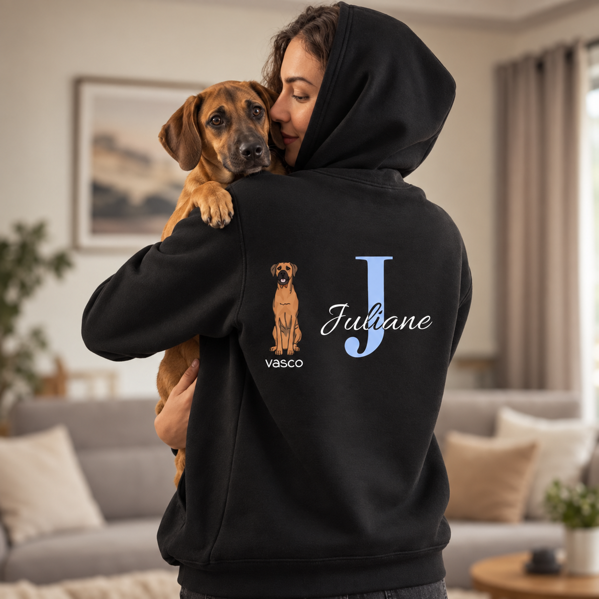 Black hoodie with custom initial and dog motif on the back.