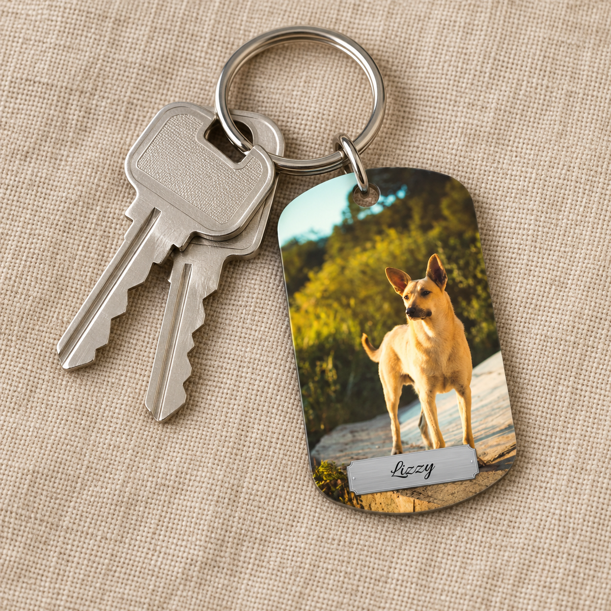Personalized keychain with photo of a dog and engraved name, with two keys.
