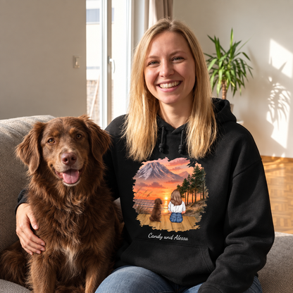 Personalized black hoodie with motif of a woman and a dog in front of a mountain landscape.