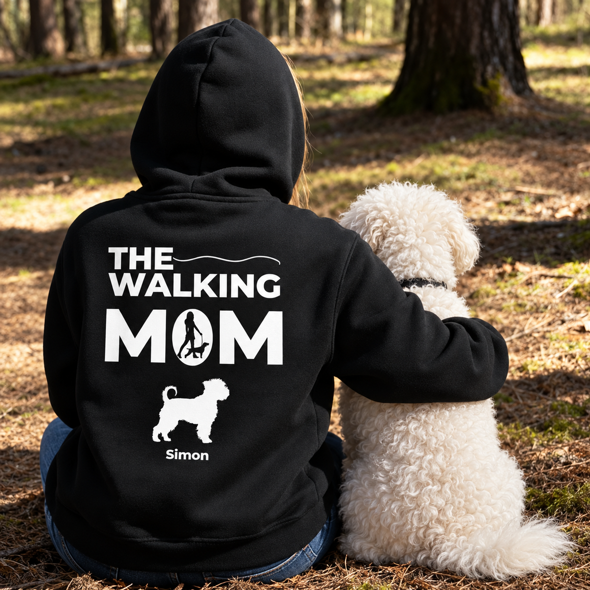 Black hoodie with white "THE WALKING MOM" print, personalized with name and dog motif, worn by a person.