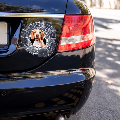 Car sticker with a picture of a dog, surrounded by a graphic shattered-glass design on black paintwork.