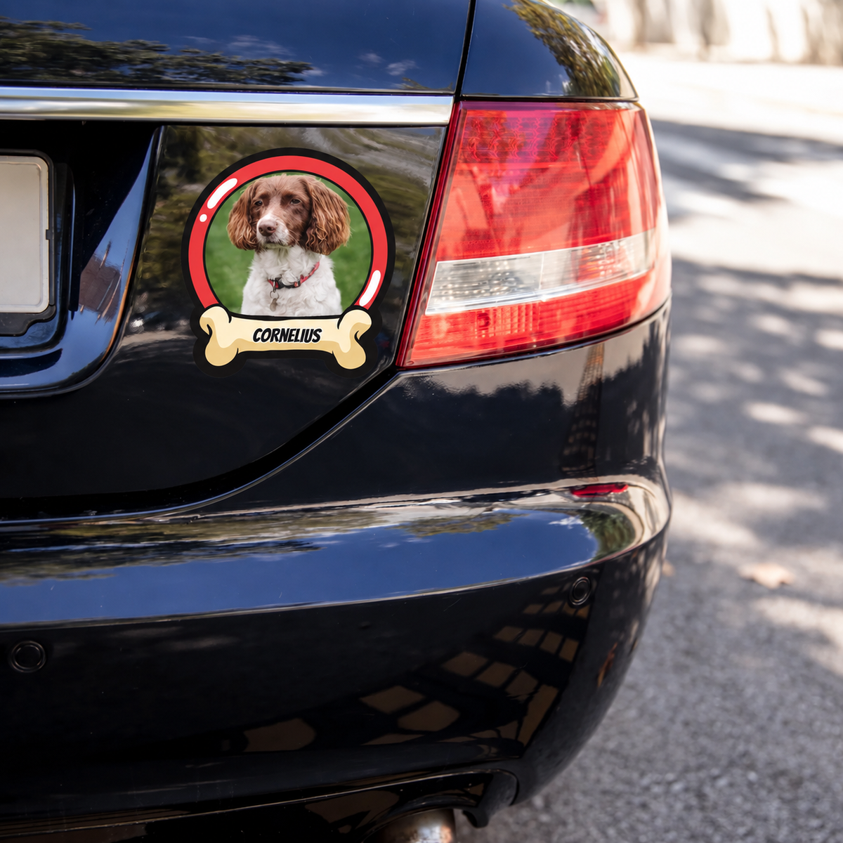 Personalized car sticker with dog picture and the name "CORNELIUS" on a black car.