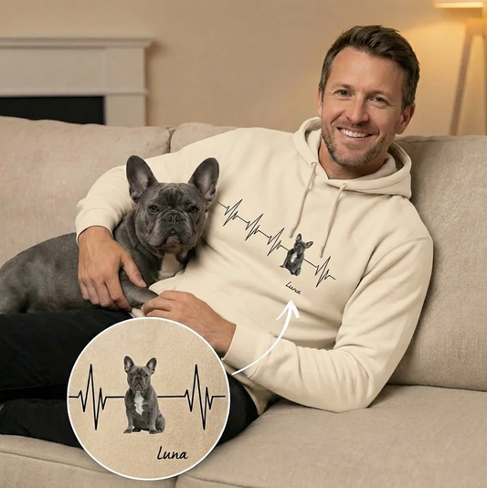 High-quality beige hoodie with heartbeat design and dog portrait, a man holding a dog on the couch.