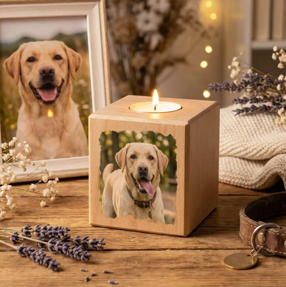 Wooden candle cube with a dog photo. Candle burning, surrounded by lavender and a picture frame.
