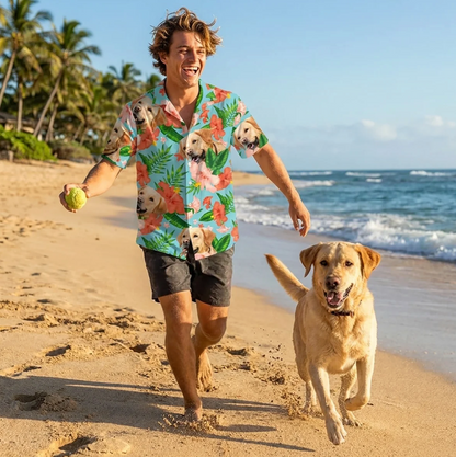 Man in a personalized Hawaiian shirt with a dog on the beach in sunny weather. Shirt with colourful flower and dog designs.