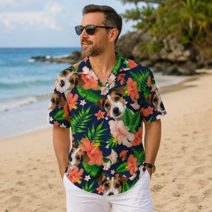 Man wearing a personalized Hawaiian shirt with dog designs and colourful flowers, on the beach.