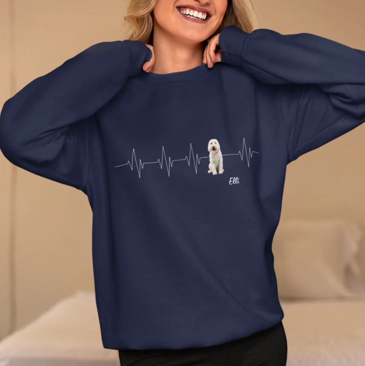 Blue sweatshirt with heartbeat pattern and illustrated dog picture.