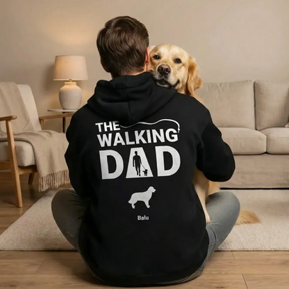 Person sitting with a dog on their lap in a black hoodie printed with "The Walking Dad".
