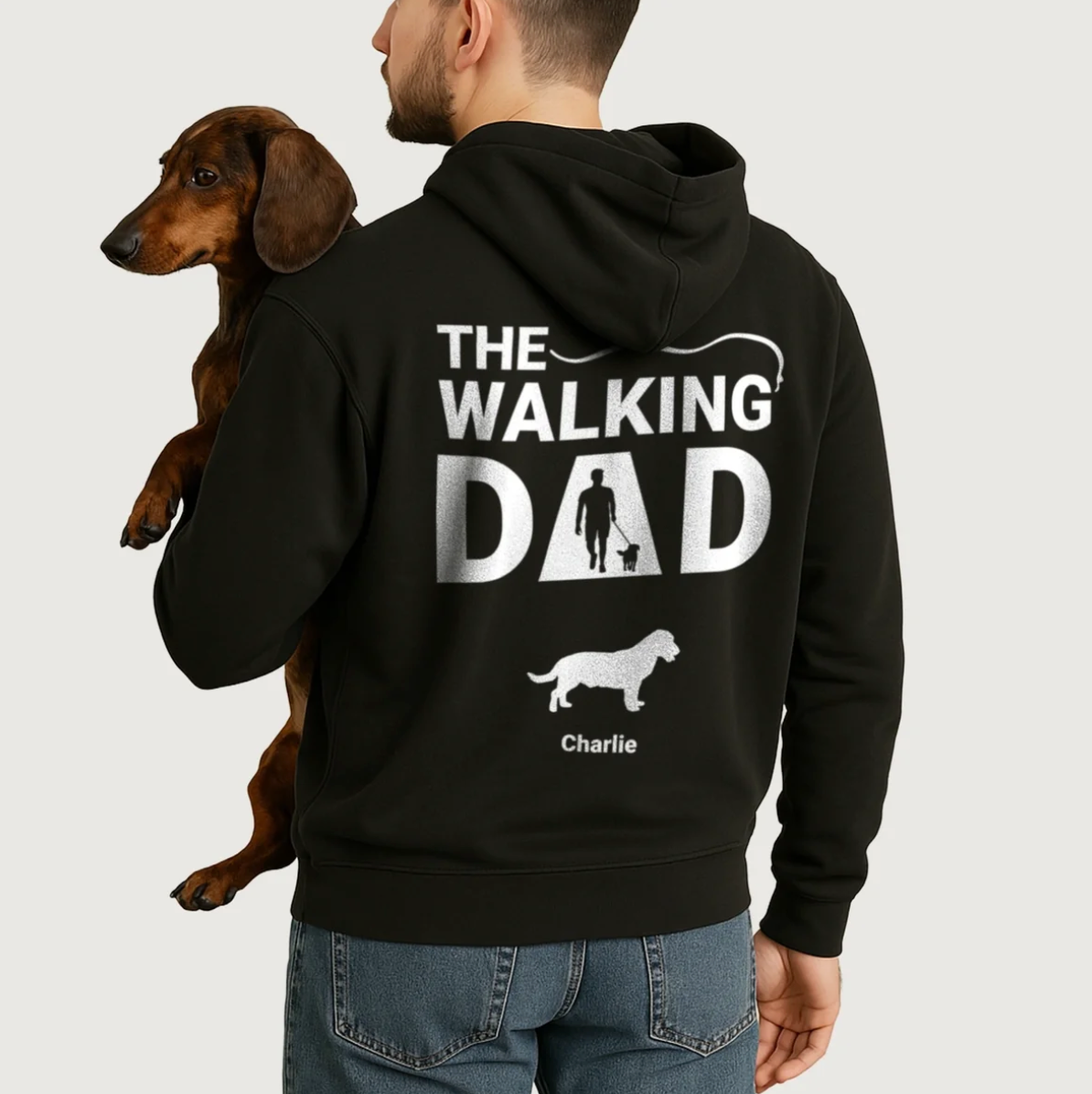 Black hoodie with personalized "The Walking Dad" print and dog designs. Worn by a man with a dog.