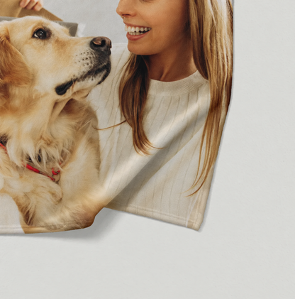 Personalized pet blanket with picture of a woman and a golden retriever, in soft tones.