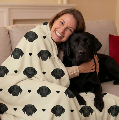 Personalized blanket with black dog heads on a beige background, wrapped around a smiling woman.