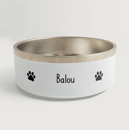 Personalized pet bowl with silver rim, the name "Balou" and black paw prints.