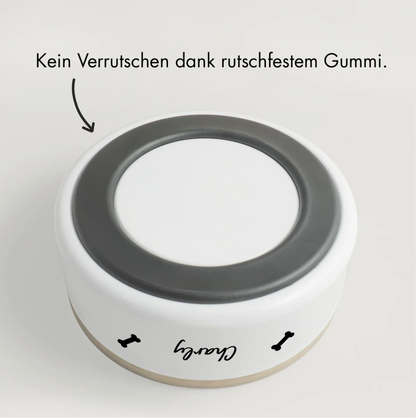 Personalized pet bowl with non-slip rubber base, white with a black inner rim.