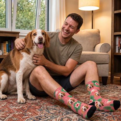 Personalized socks with bird-of-paradise design in pink, shown on a man with a dog.