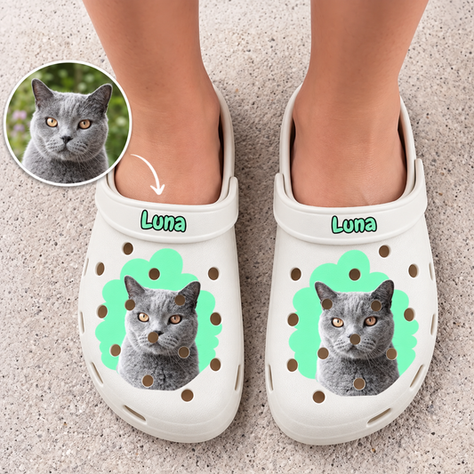 Personalized white clogs with cat and name, green design accents and ventilation holes.