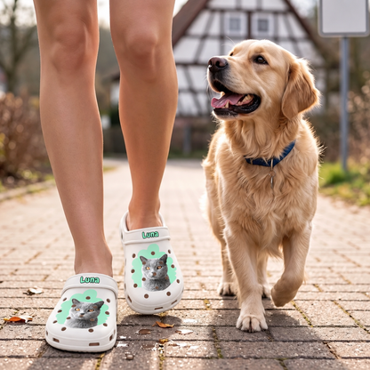 Personalized white clogs with a cat portrait, worn by a person walking a dog.
