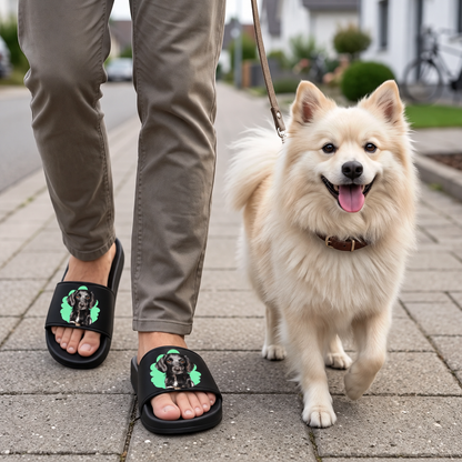 Black slides with pet portrait and green border, worn by a person walking a dog.