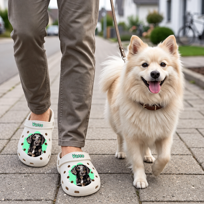 Personalized beige clogs with pet portrait, worn by a person on the street next to a dog.