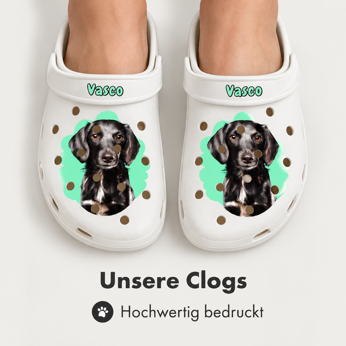 Personalized white clogs with a dog portrait and the name "Vasco" on top.