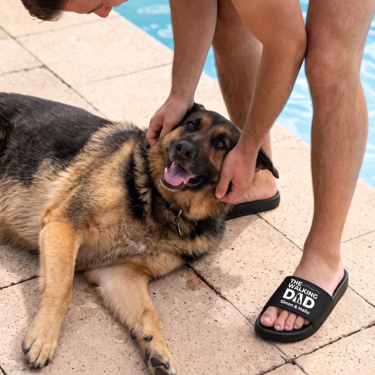 Person wearing black slides with "THE WALKING DAD" print, sitting next to a dog by the pool.