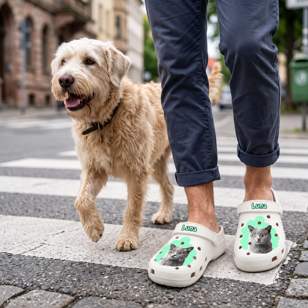 Personalized white clogs with cat portrait and the name "Luna", worn by a person with a dog on the street.